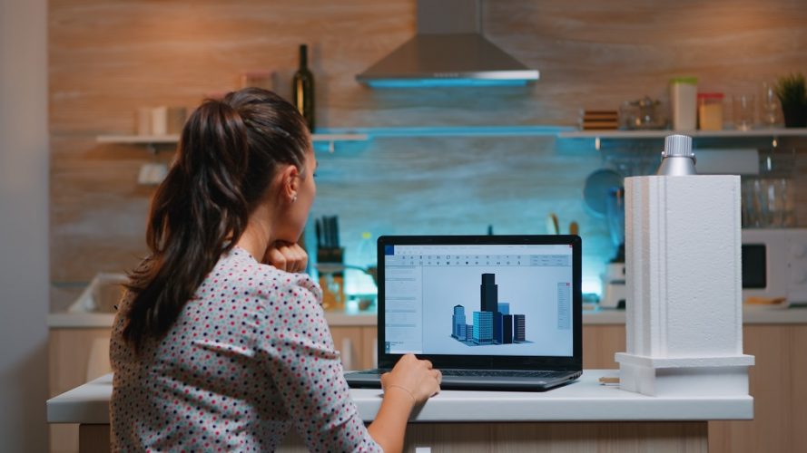 Designer using cad software to design a 3D concept of buildings working remotely overtime from home. Engineer artist creating and studying in office new modern model, determination, career.