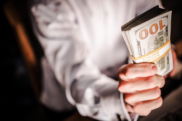 Cash Money Giveaway. Caucasian Businessman with Pile of Cash. Ten Thousand American Dollars.