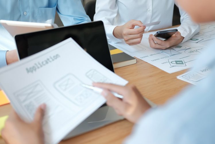 user experience UX designer designing web on smart phone layout. UI planning mobile application. developer work with business prototype